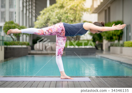 Young Asian woman doing yoga exercise Young Asian woman doing yoga exercise 34346135