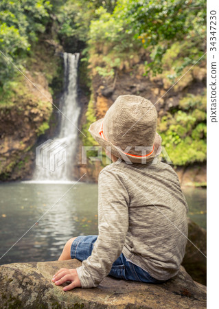 Child looking Chamouze waterfall. Mauritius Child looking Chamouze waterfall. Mauritius 34347230