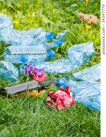 Heap of rubbish on green grass in park Heap of rubbish on green grass in park 34347779