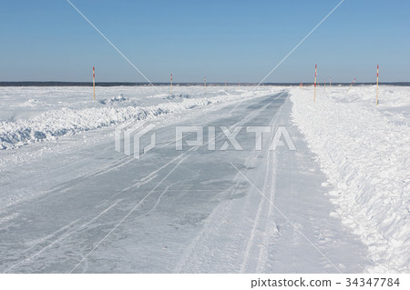 Ice road in snow on the frozen water reservoir Ice road in snow on the frozen water reservoir 34347784