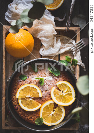 Orange cake on wooden tray table top view 34347833