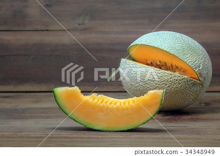 Cantaloupe melon with sliced on wooden background 34348949