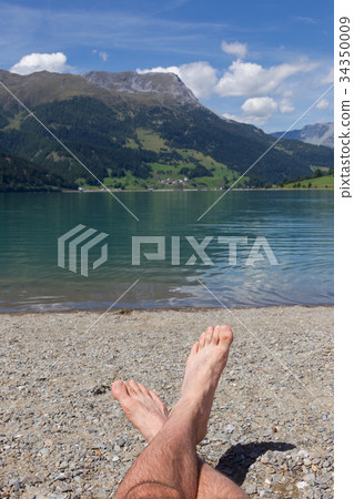 Feet on the beach, relaxing at the Reschensee Feet on the beach, relaxing at the Reschensee 34350009