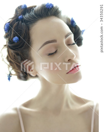 Beautiful young woman with blue muscari in her hair Beautiful young woman with blue muscari in her hair 34350291