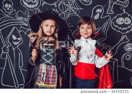 Children in scary Hallowe'en costumes stand Children in scary Hallowe'en costumes stand 34350725