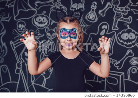 Girl in a cat costume on dark background with Girl in a cat costume on dark background with 34350960