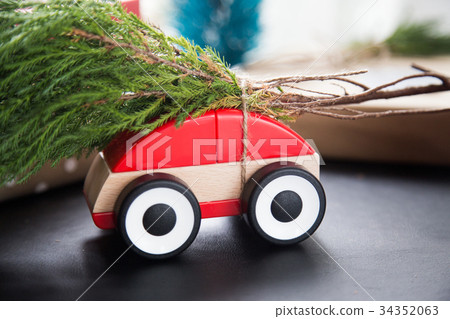 Red car toy for christmas festival with pine leaf Red car toy for christmas festival with pine leaf 34352063