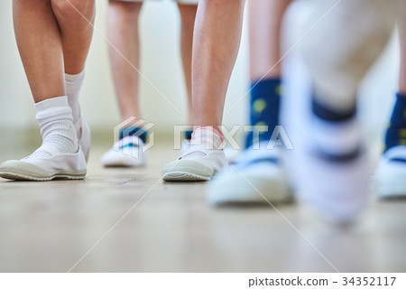 Elementary school attendance at school corridor 34352117