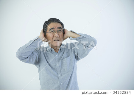 Senior man blocking ear 34352884