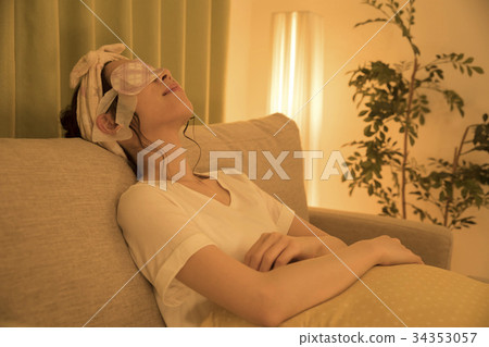Woman doing hot eye mask at night 34353057