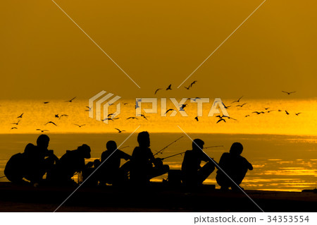 Silhouettes of people fishing on a lake at sunset. Silhouettes of people fishing on a lake at sunset. 34353554
