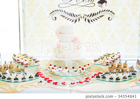Delicious sweets on wedding candy buffet with 34354841