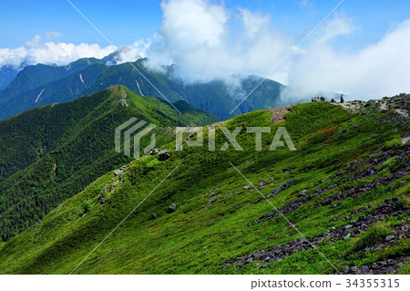 Mountain climbers and Kaikomagatake distant view of the Southern Alps and the Hokudake ridge line Mountain climbers and Kaikomagatake distant view of the Southern Alps and the Hokudake ridge line 34355315