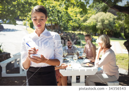 Waitress writing order on notepad 34356543