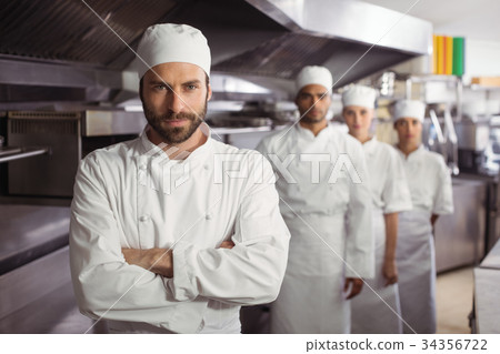 Happy chefs team standing together in commercial kitchen 34356722