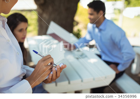 Waitress writing order on notepad 34356996