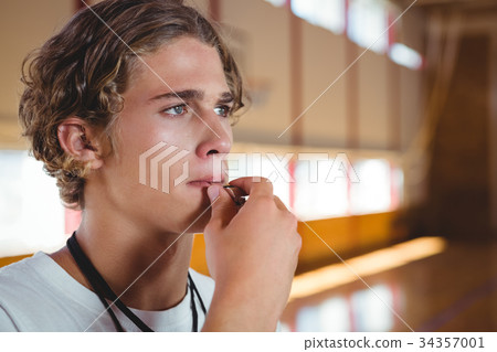 Close up of basketball coach whistling 34357001