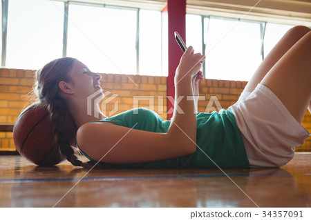 Side view of smiling woman using digital tablet in court Side view of smiling woman using digital tablet in court 34357091