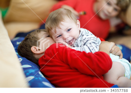 Little kid boy hugging with newborn baby girl 34357788