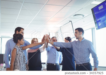Business colleagues putting their hands together 34357925