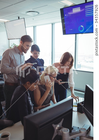 Business colleagues working together while using technologies 34357926