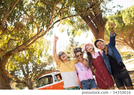 Low angle view of cheerful friends gesturing Low angle view of cheerful friends gesturing 34358016
