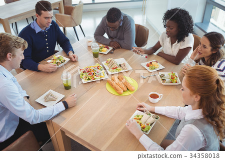 Business people having breakfast at office cafeteria Business people having breakfast at office cafeteria 34358018