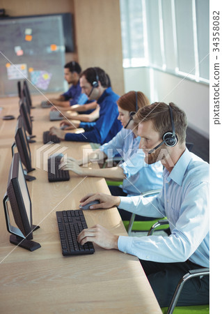 High angle view of business people working at call center High angle view of business people working at call center 34358082