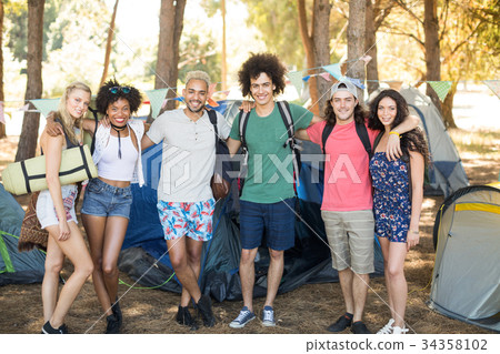 Portrait of smiling friends at campsite Portrait of smiling friends at campsite 34358102