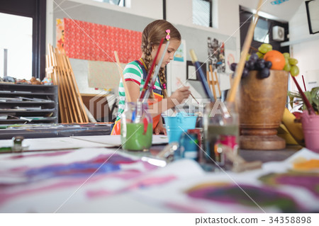 Girl painting in classroom 34358898