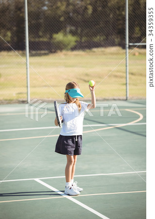 Girl playing tennis at court 34359355