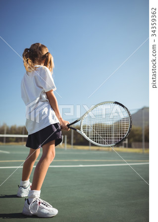 Girl holding tennis racket on court 34359362