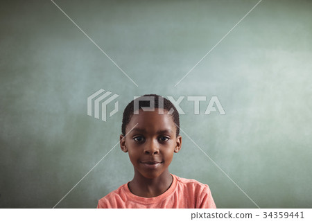 Smiling boy against blank greenboard Smiling boy against blank greenboard 34359441