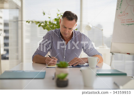 Male executive working in office 34359933