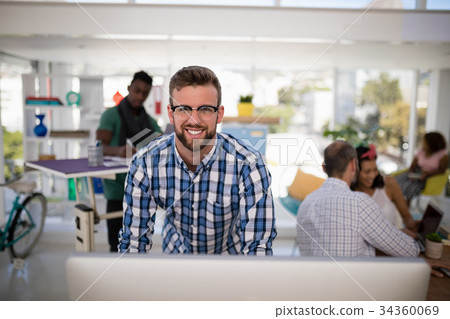 Male executive working on computer in the office Male executive working on computer in the office 34360069