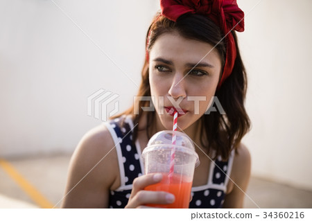 Beautiful woman drinking juice 34360216