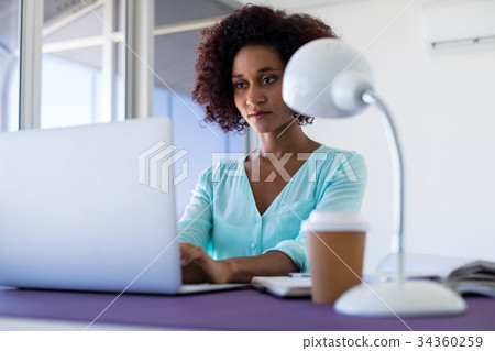 Female executive working over laptop Female executive working over laptop 34360259