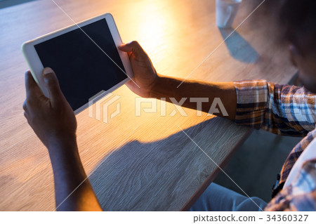 Male executive using digital tablet at his desk Male executive using digital tablet at his desk 34360327