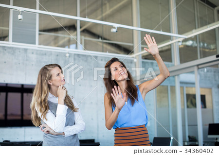 Female executives interacting with each other 34360402