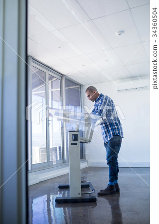 Male executive working over drafting table Male executive working over drafting table 34360504