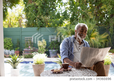 Senior man reading newspaper 34360896