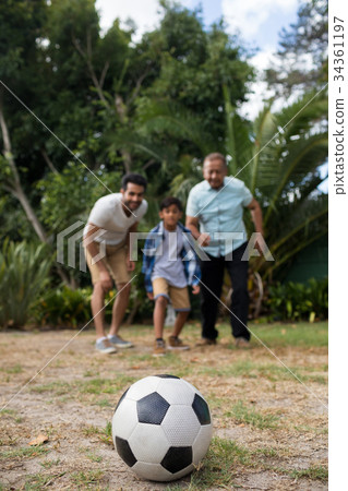 Family looking at soccer ball 34361197