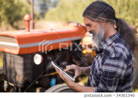 Man using digital tablet in olive farm 34361340