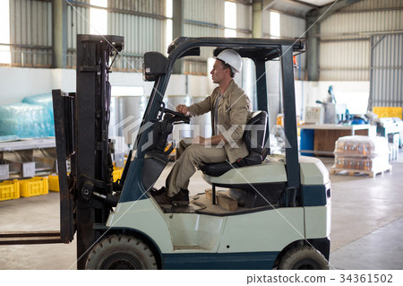 Worker driving forklift 34361502
