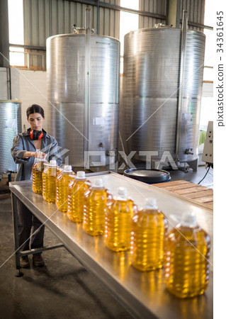 Female worker working in oil factory 34361645