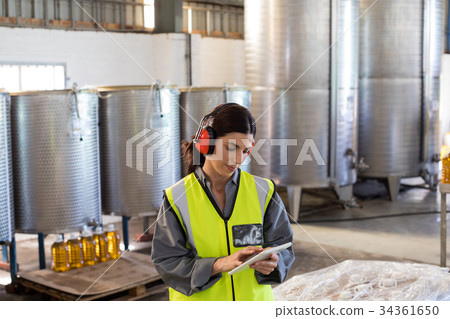 Female technician using digital tablet 34361650
