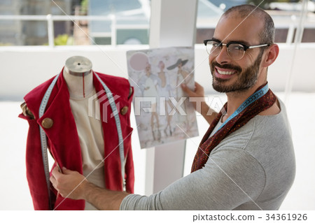 Portrait of smiling designer standing by mannequin Portrait of smiling designer standing by mannequin 34361926
