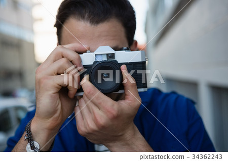 Man photographing with camera 34362243