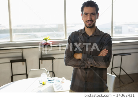 Portrait of confident man standing at office 34362431