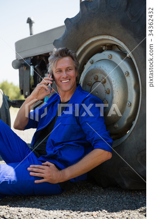 Worker talking on mobile phone 34362432